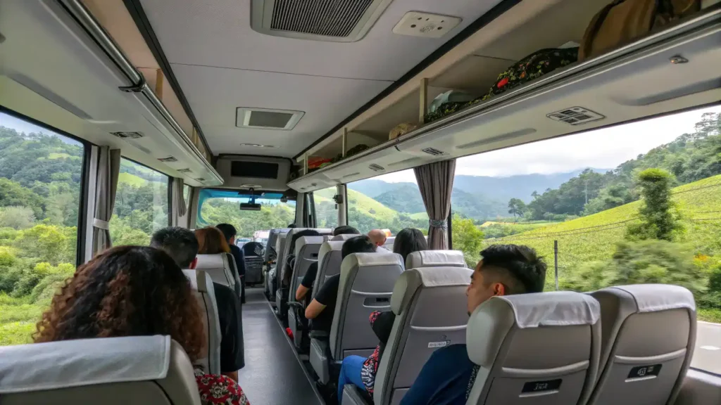 Interior view of a comfortable bus traveling through the Malaysian countryside with scenic views outside.