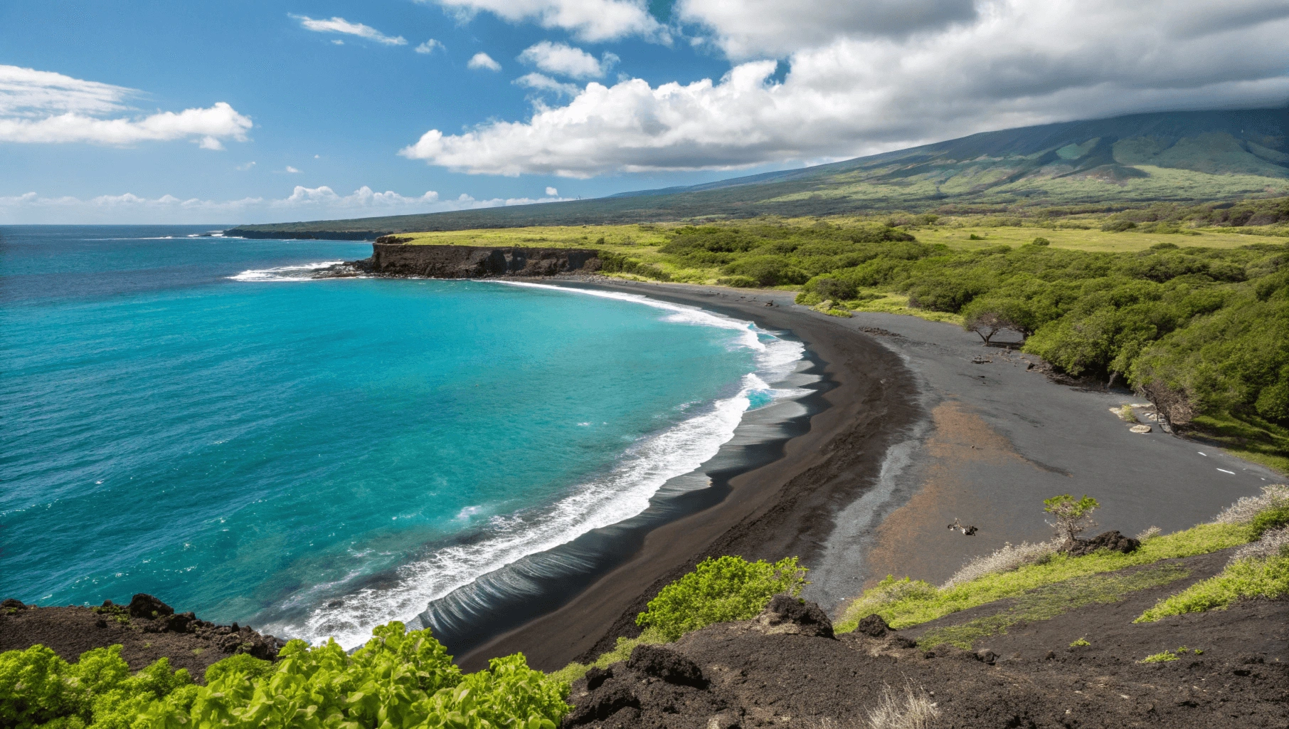 Black sand shoreline of 49 Black Sand Beach (Honoka'ope Beach) with turquoise waters and Mauna Kea in background