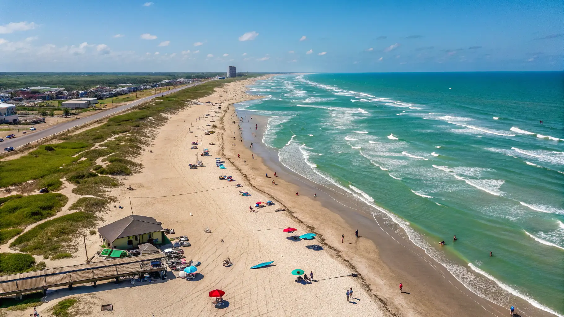 Aerial view of Surfside Beach, Texas, featuring sandy shores and beachgoers.