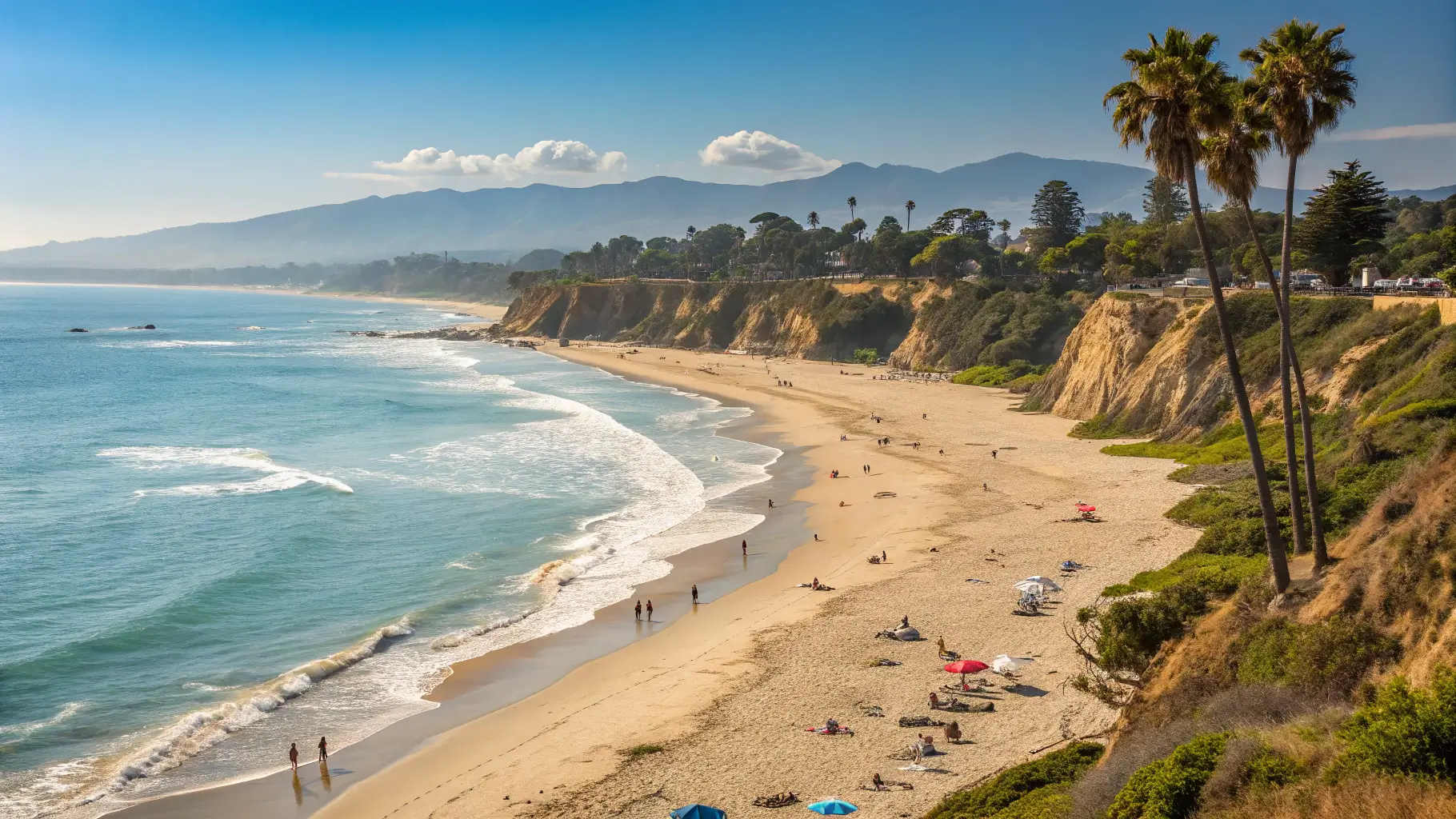 A picturesque scene of Butterfly Beach in Santa Barbara, featuring golden sands, clear blue waters, and people enjoying the beach.